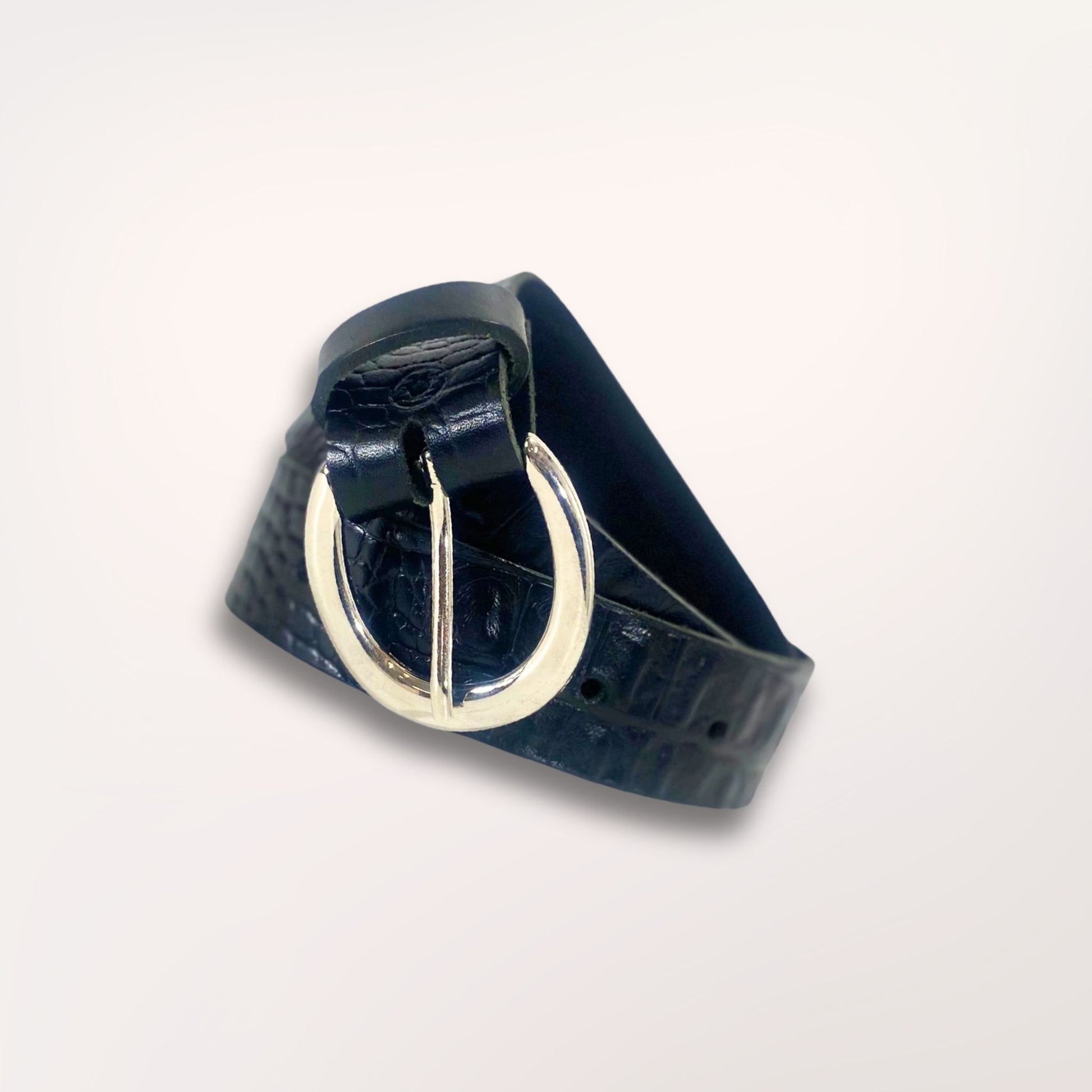 Ceinture artisanale noire façon caïman présentée enroulée, soulignant la souplesse et la qualité du cuir de vachette Labossa.